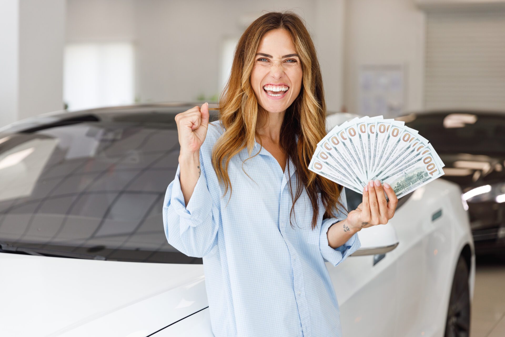 Woman customer buyer client in shirt hold fan cash money dollar banknotes dowinner gesture want to buy new auto in car automobile showroom vehicle salon dealership store motor show inside Sale concept auto insurance